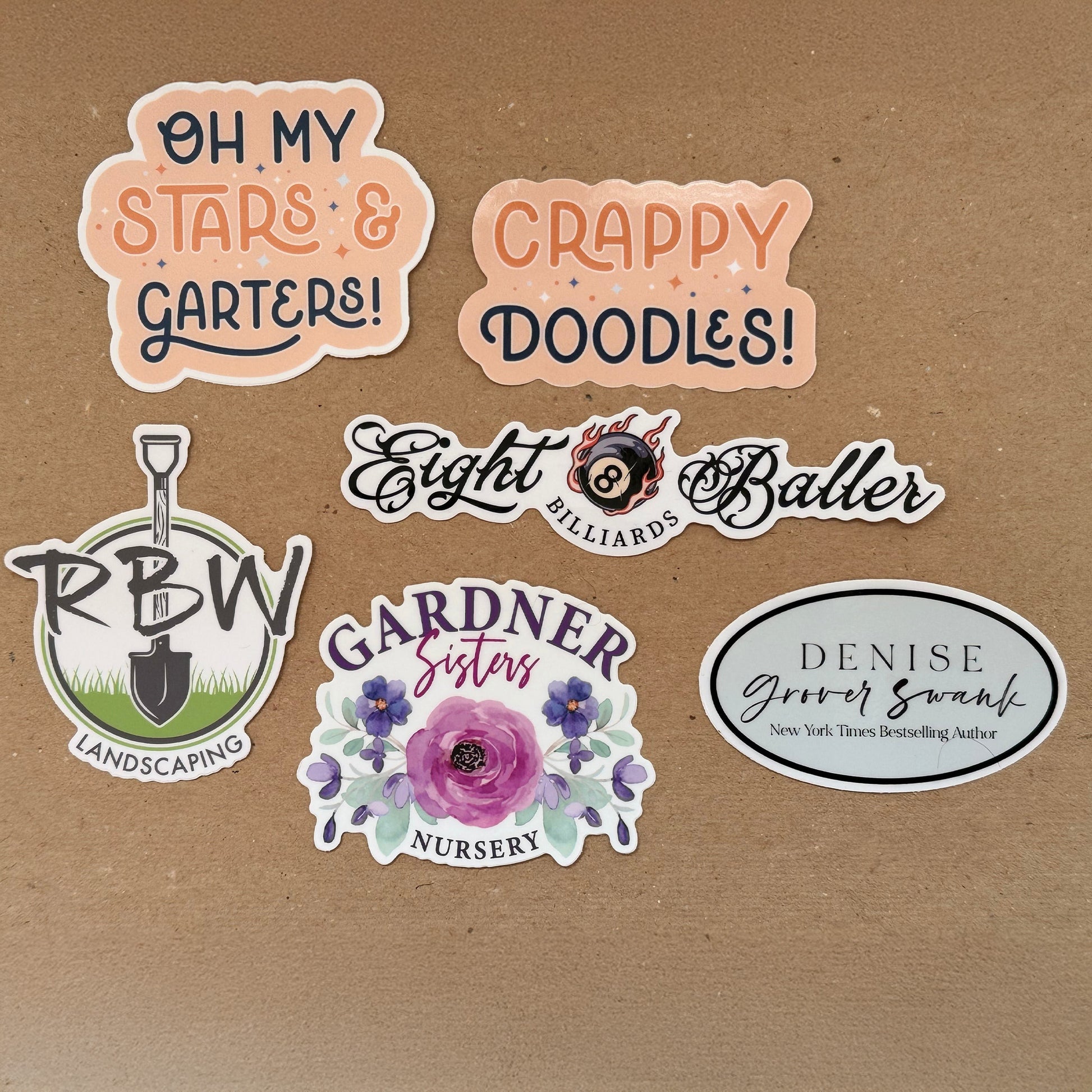 Collection of various stickers with different designs and text on a brown background