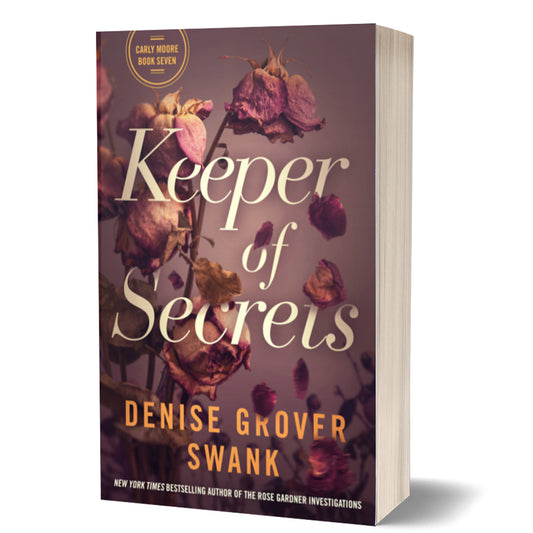 This image features the paperback book titled "Keeper of Secrets" by Denise Grover Swank, which is the seventh book in the Carly Moore series. The book's cover displays an elegant and dark design, with a subtle floral motif in the background.