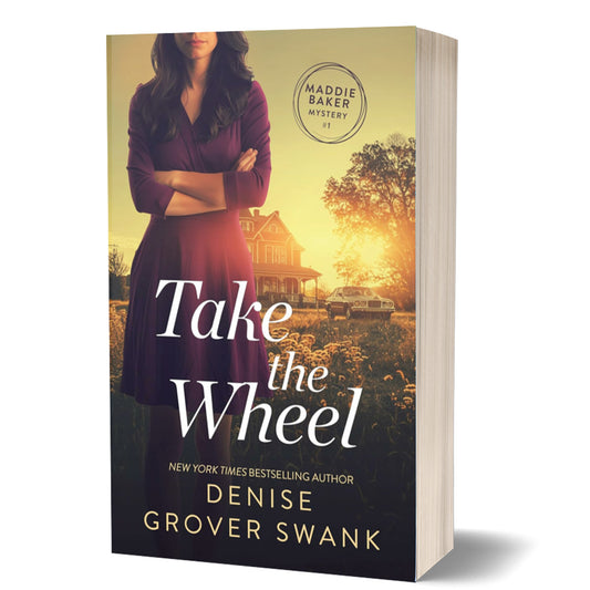 This image features the cover of the paperback book "Take the Wheel" by Denise Swank, which was previously titled "Blind Bake." The cover displays a striking and serene rural scene with a woman in a purple dress and a blue sky in the background.