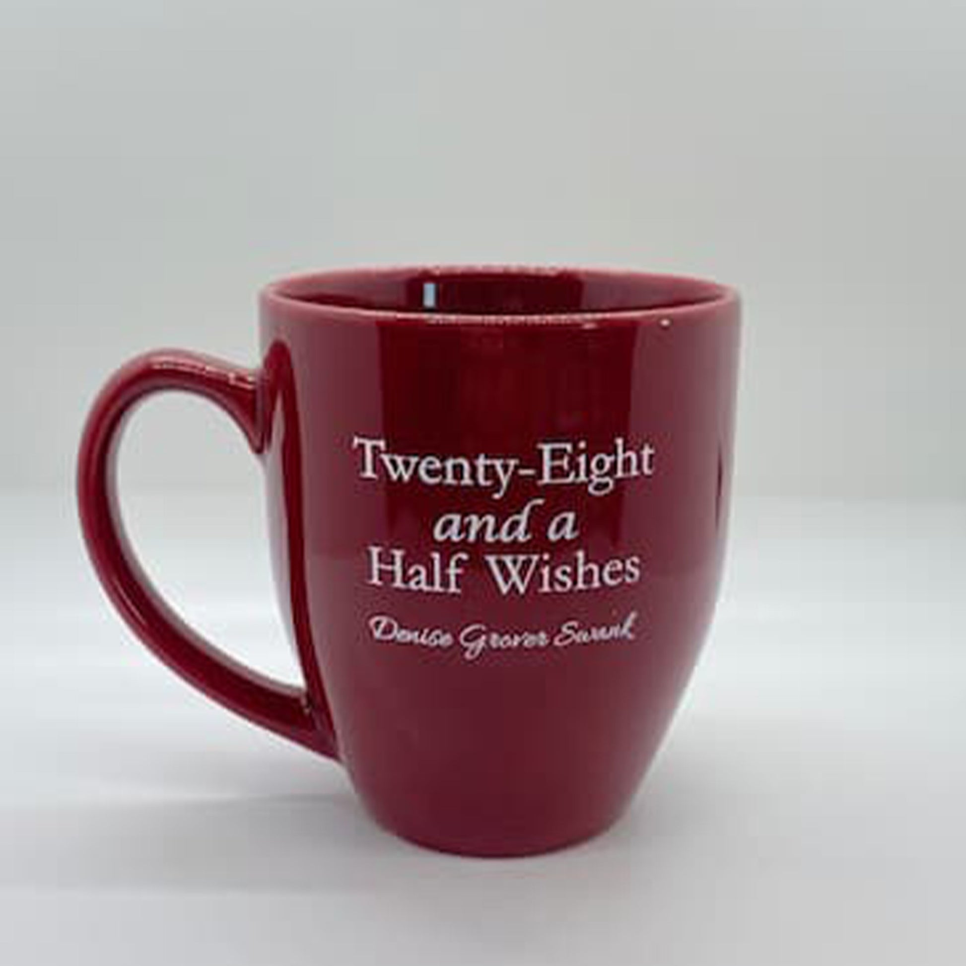 Red mug with white text on a white background